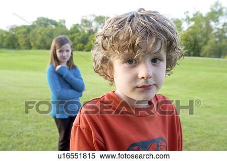 Stock Photography - Six year old brother in foreground, 8 year old sister in background, Winnipeg, Canada. Fotosearch