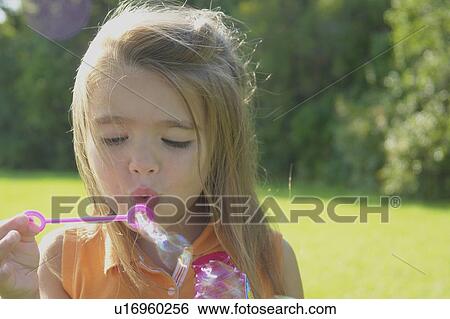 Six year old girl blowing bubbles in park, Winnipeg, Canada View Large Photo Image Stock Photograph - Six year old girl blowing bubbles in park, Winnipeg, Canada. Fotosearch