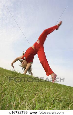 Stock Photograph - Six year old girl doing cartwheel, Winnipeg, Canada. Fotosearch