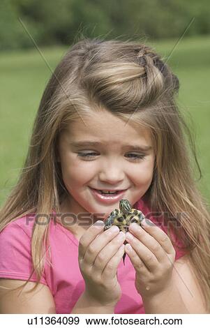 Stock Photo - Six year old girl holding turtle, Winnipeg, Canada. Fotosearch