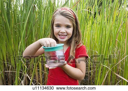 Six year old girl in wetland, with frog in collecting jar, Winnipeg, Canada View Large Photo Image Stock Image - Six year old girl in wetland, with frog in collecting jar, Winnipeg, Canada. Fotosearch