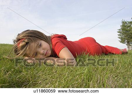 Six year old girl laying on grass, Winnipeg, Canada View Large Photo Image Stock Photo - Six year old girl laying on grass, Winnipeg, Canada. Fotosearch