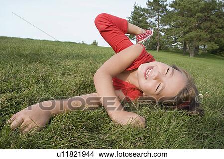 Six year old girl running on grass, Winnipeg, Canada View Large Photo Image Picture - Six year old girl running on grass, Winnipeg, Canada. Fotosearch