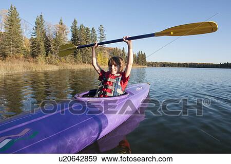 Smiling 10 year old boy holding paddle above kayak, Lake Katherine, Riding Mountain National Park, Manitoba View Large Photo Image Stock Photo - Smiling 10 year old boy holding paddle above kayak, Lake Katherine, Riding Mountain National Park, Manitoba. Fotosearch