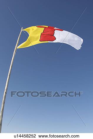 The flag of Nunavut, Canada's true Arctic territory, rippling in a cold winter wind before blue skies. View Large Photo Image Stock Image - The flag of Nunavut, Canada's true Arctic territory, rippling in a cold winter wind before blue skies.. Fotosearch