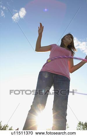Stock Image - Thirteen year old girl with hula hoop, Winnipeg, Canada. Fotosearch