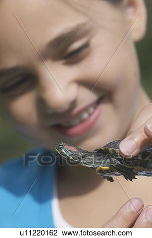 Stock Image - Turtle held by eight year old girl, Winnipeg, Canada. Fotosearch
