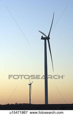 Stock Photo - Two wind turbines at sunset. Fotosearch