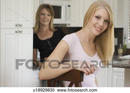 Two women in kitchen, one holding compact flourescent light bulb, Brandon, Canada View Large Photo Image Stock Photography - Two women in kitchen, one holding compact flourescent light bulb, Brandon, Canada. Fotosearch