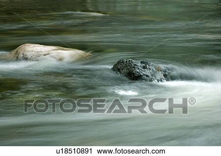 Stock Image - Water flowing over rocks, Gaspesie, Sainte-Anne River, Quebec. Fotosearch