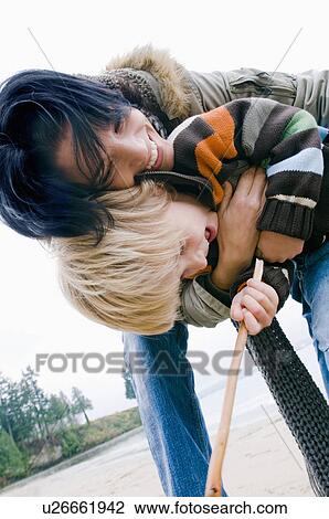Stock Image - Woman embraces young son on beach, Vancouver, British Columbia. Fotosearch