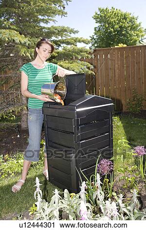 Woman with compost pail beside composter in backyard, Winnipeg, Canada View Large Photo Image Stock Image - Woman with compost pail beside composter in backyard, Winnipeg, Canada. Fotosearch