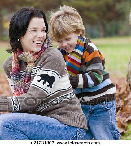 Young boy and mother playing together outdoors in autumn, Vancouver, British Columbia View Large Photo Image Stock Photo - Young boy and mother playing together outdoors in autumn, Vancouver, British Columbia. Fotosearch