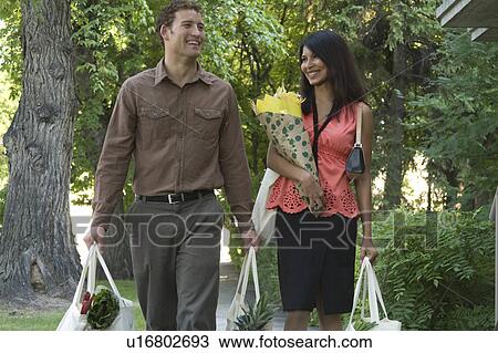Young couple carrying groceries in cloth bags, Winnipeg, Canada View Large Photo Image Stock Image - Young couple carrying groceries in cloth bags, Winnipeg, Canada. Fotosearch
