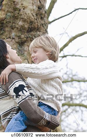 Young mother holds smiling son, Vancouver, British Columbia View Large Photo Image Stock Image - Young mother holds smiling son, Vancouver, British Columbia. Fotosearch