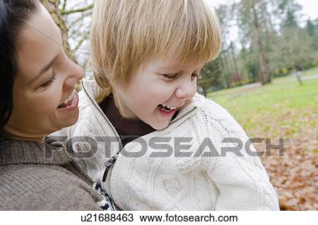 Young mother holds smiling son, Vancouver, British Columbia View Large Photo Image Stock Image - Young mother holds smiling son, Vancouver, British Columbia. Fotosearch