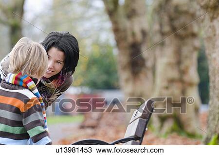 Young mother listening to son outdoor in autumn, Vancouver, British Columbia View Large Photo Image Stock Image - Young mother listening to son outdoor in autumn, Vancouver, British Columbia. Fotosearch