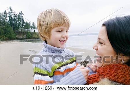 Stock Photo - Young woman and boy at beach, Vancouver, British Columbia. Fotosearch