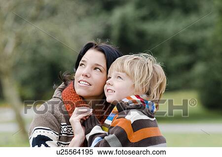 Stock Photography - Young woman and boy looking upward, Vancouver, British Columbia. Fotosearch