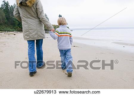 Young woman and boy walking on beach, Vancouver, British Columbia View Large Photo Image Stock Image - Young woman and boy walking on beach, Vancouver, British Columbia. Fotosearch