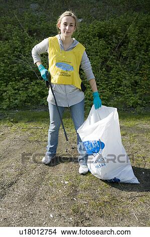 Picture - Young woman helps with community clean-up, Vancouver, Canada. Fotosearch