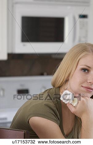 Young woman holding compact fluorescent bulb in kitchen, Brandon, Canada View Large Photo Image Stock Image - Young woman holding compact fluorescent bulb in kitchen, Brandon, Canada. Fotosearch