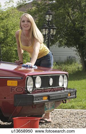 Young woman wiping hood of car, Brandon, Canada View Large Photo Image Stock Image - Young woman wiping hood of car, Brandon, Canada. Fotosearch