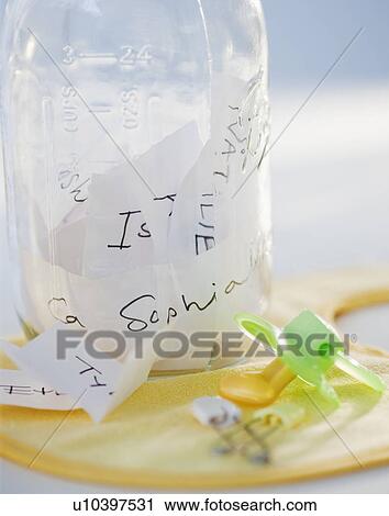 A baby bottle full of baby names beside a pacifier View Large Photo Image Stock Image - A baby bottle full of baby names beside a pacifier. Fotosearch