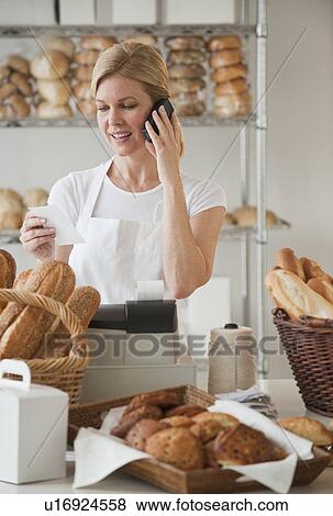 A baker in a bakery View Large Photo Image Stock Photo - A baker in a bakery. Fotosearch