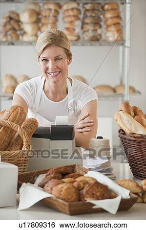 Stock Photograph - A baker in a bakery. Fotosearch