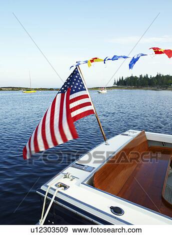 A boat with an American flag View Large Photo Image Stock Photo - A boat with an American flag. Fotosearch