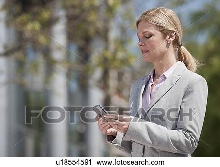 Stock Image - A businesswoman outdoors. Fotosearch