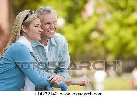 A couple at a park View Large Photo Image Stock Image - A couple at a park. Fotosearch