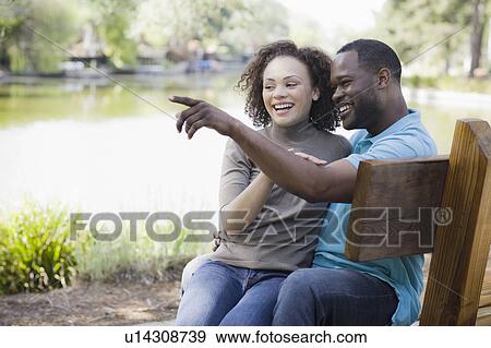 A couple at a park View Large Photo Image Stock Photo - A couple at a park. Fotosearch