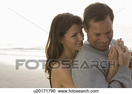 Stock Image - A couple at the beach. Fotosearch