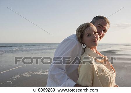 Stock Photo - A couple at the beach. Fotosearch