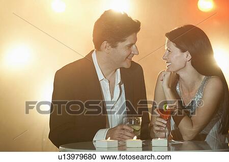 A couple enjoying cocktails View Large Photo Image Stock Image - A couple enjoying cocktails. Fotosearch