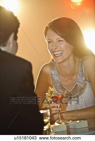 Stock Image - A couple enjoying cocktails. Fotosearch