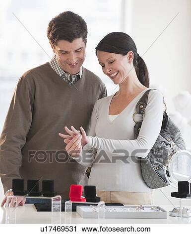 A couple looking at engagement rings View Large Photo Image Stock Image - A couple looking at engagement rings. Fotosearch