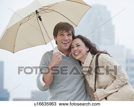 A couple outdoors in the rain View Large Photo Image Stock Image - A couple outdoors in the rain. Fotosearch