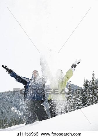 Stock Image - A couple outdoors in the snow. Fotosearch
