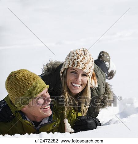 Stock Image - A couple outdoors in the snow. Fotosearch