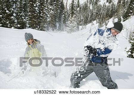 Stock Image - A couple outdoors in the snow. Fotosearch
