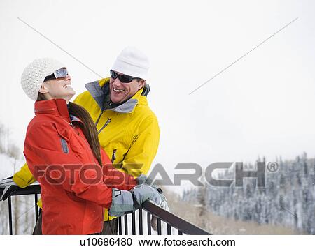 A couple relaxing on deck at ski resort View Large Photo Image Stock Image - A couple relaxing on deck at ski resort. Fotosearch