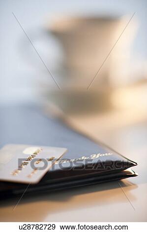 Stock Photo - A credit card on a restaurant check. Fotosearch