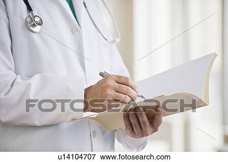 Stock Photo - A doctor writing in a file. Fotosearch