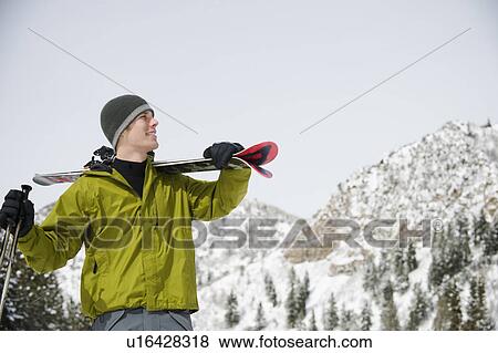 A downhill skier carrying skis View Large Photo Image Stock Photo - A downhill skier carrying skis. Fotosearch