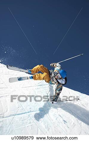 Stock Photo - A downhill skier doing a trick. Fotosearch