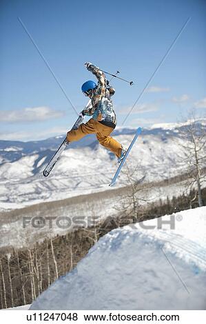 A downhill skier jumping View Large Photo Image Stock Photo - A downhill skier jumping. Fotosearch