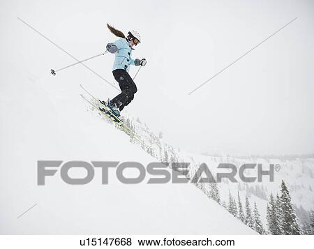 A downhill skier jumping View Large Photo Image Stock Photo - A downhill skier jumping. Fotosearch
